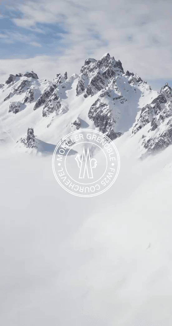 A snow-covered alpine peak with a Moncler Courchevel stamp
