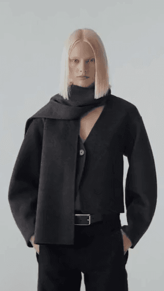 Club Monaco: a blonde model in a black cropped jacket and scarf