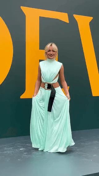 Loewe: a model in a mint cut-out gown against a giant yellow letter